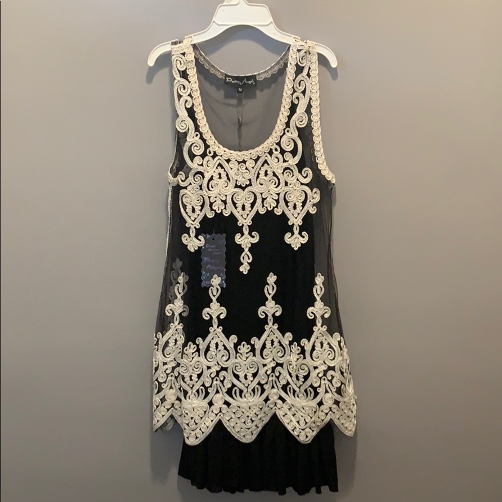 Black sleeveless dress with white stitching